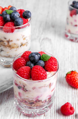 Muesli with yogurt and berries in a glass On a wooden table. Fitness food. Copy space. High quality photo