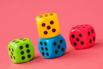 Four colorful dice on pink background