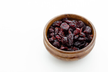 Dried blueberries in wooden bowl. Dry fruits.