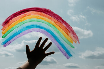 A child painted a rainbow on glass during a Covid-19 quarantine at home as a sign of hope.
Healthcare and childhood concept