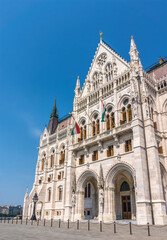 Fototapeta na wymiar Budapest, Hungary - August 31, 2019: majestic facade of the Hungarian Parliament building, built in the neo-Gothic style. Famous state building and most popular tourist attraction in Budapest
