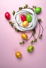 Colored eggs into a nest on a multicolored background .