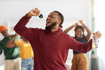 Funny black guy singing karaoke at home