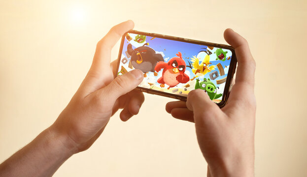 Los Angeles, California, USA - 4 May 2021 Hands holding a smartphone with Angry Birds game on display screen, Illustrative Editorial