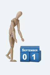 September 1. Blue wooden cubes with a date and a wooden man standing next to