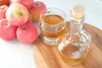 apple vinegar in glass bottle with fresh green apple on table 