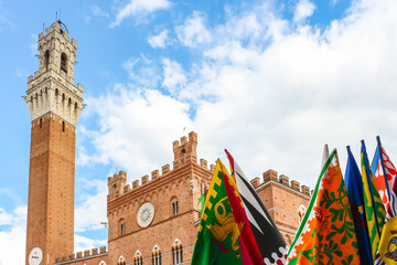 Siena, Italy. View of Torre del Mangia, famous tower at the Siena main square (Piazza del Campo). - obrazy, fototapety, plakaty