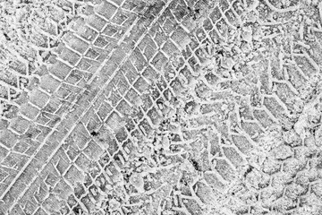 Trace of car tires in the snow. Close up view from above