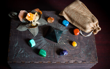 A fortune teller, witch stuff on a table, candles and fortune-telling objects. The concept of...