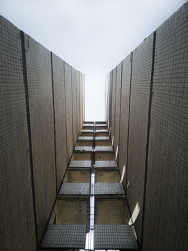 Balconies between the walls of two skyscrapers of an old Soviet house view from the bottom up.