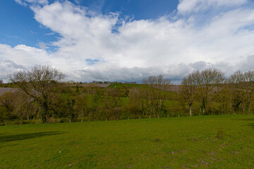 A dramatic sky during spring over the dutch rolling hills in the south of Limburg close to Maastricht.