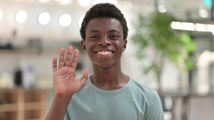 Portrait of Cheerful Young African Man Waving at the Camera