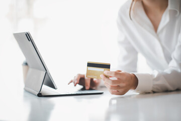 Obraz na płótnie Canvas Woman hand using laptop Mockup and credit card for shopping payment online at home.E-commerce and online shopping concept,