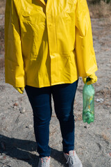 Unrecognizable woman standing showing the garbage she has picked up