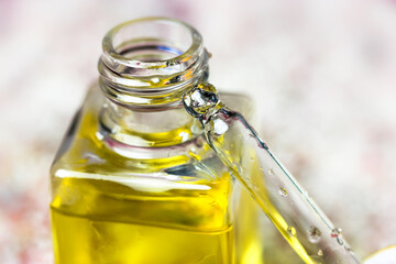Pipette with liquid oil in a glass transparent bottle to moisturize a cuticle. Essence for skin...
