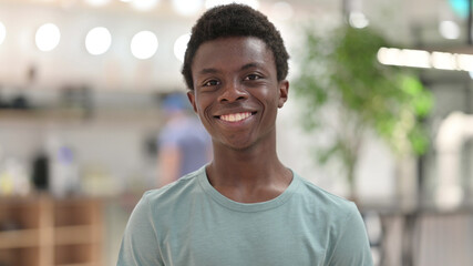 Portrait of Smiling Young African Man Looking at Camera