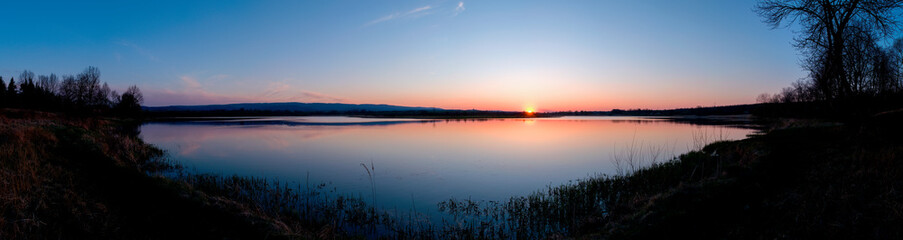 Panorama lake view in sunrise time .Sunrise at the lake
