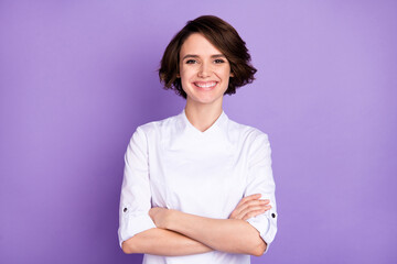 Photo of happy nice young woman folded arms good mood smile chef isolated on purple color background