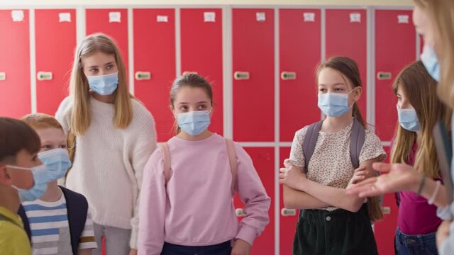 Video of teacher and children talking in the school corridor. Shot with RED helium camera in 8K.