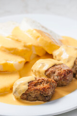 minced meat ball with creamy sauce and dumplings