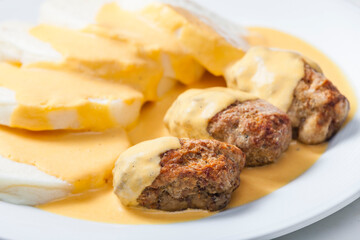 minced meat ball with creamy sauce and dumplings