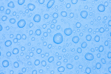 Random water drops on the blue PVC surface