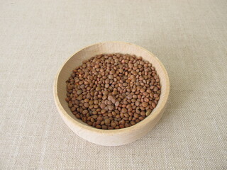 Brown mountain lentils in a wooden bowl