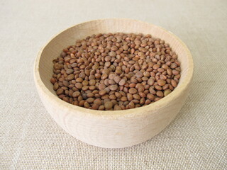 Brown mountain lentils in a wooden bowl