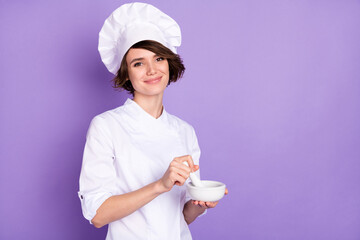 Photo of positive charming young woman hold mortar and pestle smile grind isolated on purple color...