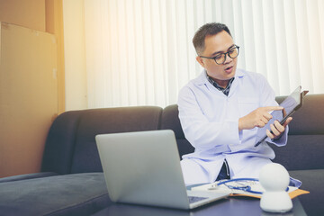 Asian doctor using video call to explain medical consultation online with patient on webcam virtual...