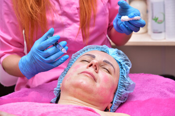 Beautician makes beauty injections. Anti-aging facial skin care, anti-wrinkle and sagging skin. 
