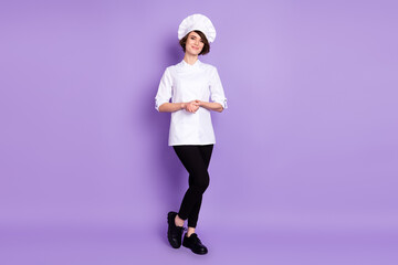 Full length body size view of attractive cheerful girl chef posing isolated over pastel violet...