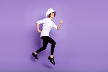Full length body size view of lovely cheerful chef jumping running fast isolated over bright violet purple color background