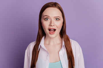 Photo of astonished girl show omg emotion expression isolated on violet background