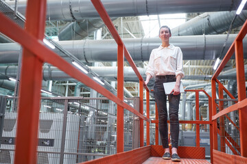 Business woman in Industrial Carpentry factory - production of wooden boards with modern machines