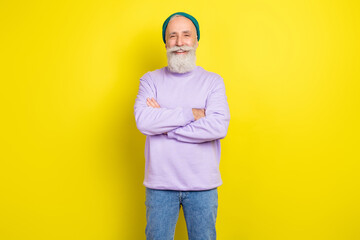 Photo portrait of aged man smiling cheerful with folded hands in stylish clothes isolated vibrant yellow color background