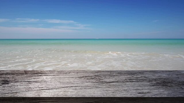 Professional Video. 4K Top wood table on beach sea outdoor.