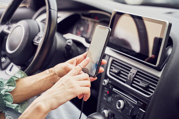 Close up girl charging phone in car