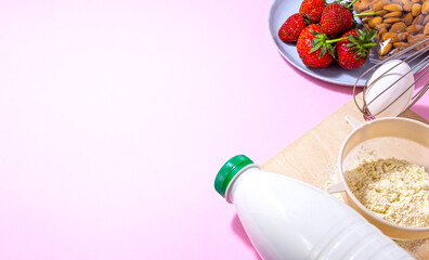 Ingredients for making strawberry cake on white wooden background, top view.