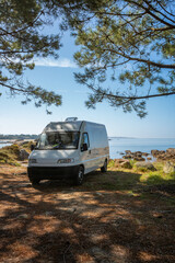 Fototapeta na wymiar Camper van on a wild beach in Arousa island living van life in Galicia, Spain