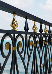 Forged detail. 3D rendering. Iron railing. Metal work. Gold decor. Balcony design. Luxury handrails. Black and gold decor. Iron fence. Blacksmithing. Architectural elements. Bokeh. Blur background.	