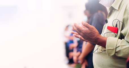senior man praying worship church on white background.Old man hand praying,Hands folded in...