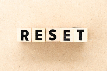 Alphabet letter block in word reset on wood background