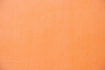 light orange painted wall outdoors as background close up, pink background © Виктория Котлярчук