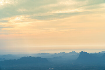 Fototapeta premium Sunrise at mountain cliff with mountain background. Nature park and outdoor landscape background