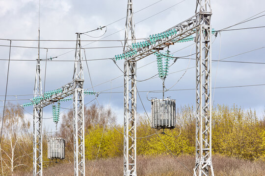 Two substation line traps electric communication or high frequency stoppers, maintenance-free parallel resonant circuit. Metal constructions and pylons, wires, high voltage electric glass insulators.