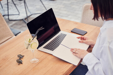 Top view of businesswoman making notes in notebook