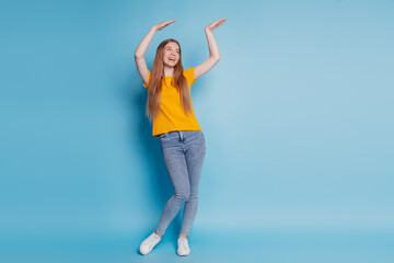 Portrait of carefree lady dance enjoy wear casual clothes on blue background