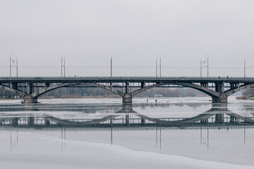 photo of the ice-covered river on which fishermen catch fish, but the ice has already begun to melt...