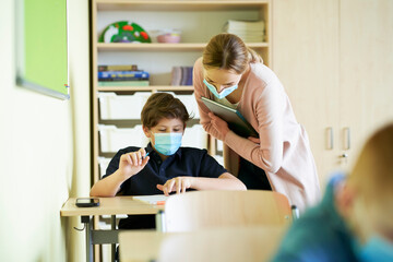 Teacher helping student during a pandemic